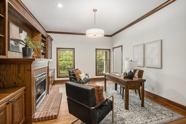 3113 Miller Rd, Ann Arbor, MI 48103 - home office featuring crown molding, baseboards, a brick fireplace, light wood-style flooring, and recessed lighting