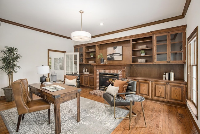 3113 Miller Rd, Ann Arbor, MI 48103 - home office with crown molding, light wood-type flooring, and a brick fireplace
