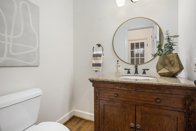 3113 Miller Rd, Ann Arbor, MI 48103 - bathroom featuring baseboards, toilet, vanity, and wood finished floors