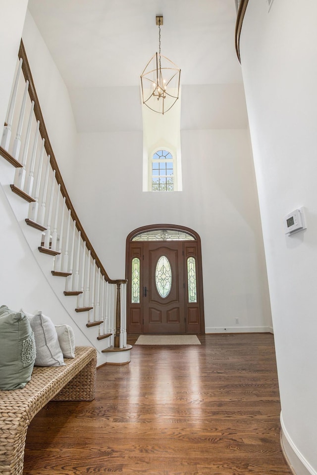 3113 Miller Rd, Ann Arbor, MI 48103 - entrance foyer with a high ceiling, a chandelier, wood finished floors, stairs, and baseboards