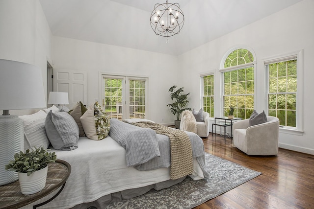 3113 Miller Rd, Ann Arbor, MI 48103 - bedroom with a chandelier, a high ceiling, wood finished floors, and baseboards