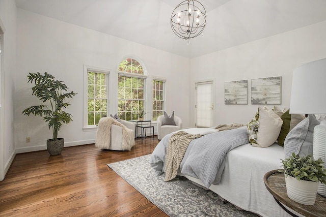 3113 Miller Rd, Ann Arbor, MI 48103 - bedroom featuring a chandelier, wood finished floors, baseboards, and a towering ceiling