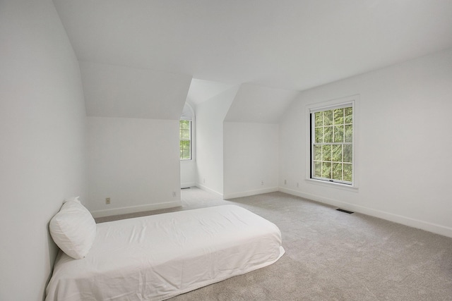 3113 Miller Rd, Ann Arbor, MI 48103 - bedroom with vaulted ceiling, baseboards, and light carpet