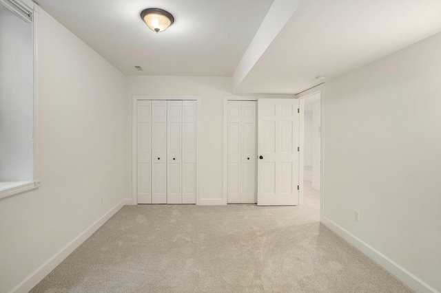 3113 Miller Rd, Ann Arbor, MI 48103 - unfurnished bedroom featuring multiple closets, carpet flooring, and baseboards