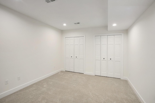 3113 Miller Rd, Ann Arbor, MI 48103 - unfurnished bedroom featuring multiple closets, light colored carpet, recessed lighting, and baseboards
