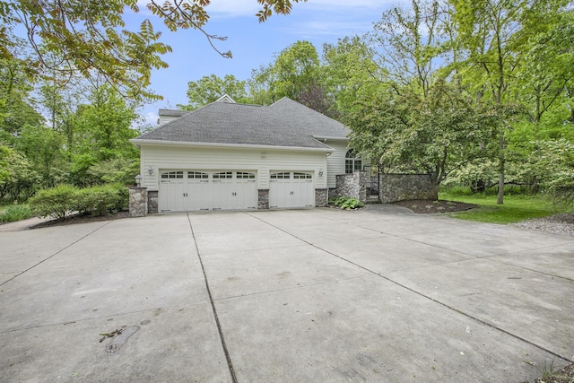 3113 Miller Rd, Ann Arbor, MI 48103 - view of property exterior with stone siding, concrete driveway, and an attached garage