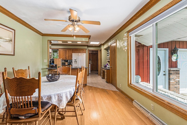 2639 Dutch Acres, Allegan, MI 49010 - dining area with light wood-style floors, plenty of natural light, ceiling fan, baseboard heating, and ornamental molding