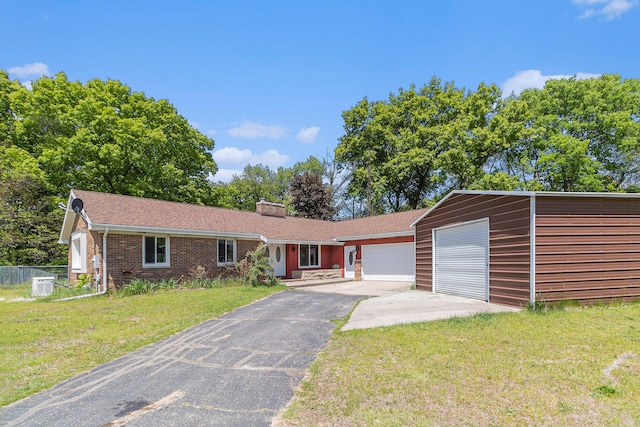 2639 Dutch Acres, Allegan, MI 49010 - single story home with a garage, asphalt driveway, a chimney, cooling unit, and brick siding