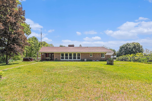 2639 Dutch Acres, Allegan, MI 49010 - back of house featuring brick siding and a chimney