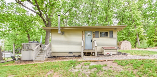 493 Swan Ln, Coldwater, MI 49036 - view of front facade with entry steps, crawl space, a wooden deck, and stairway