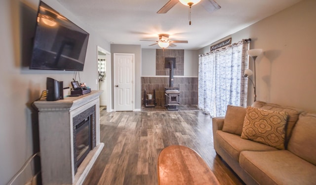 493 Swan Ln, Coldwater, MI 49036 - living area with a ceiling fan, wood finished floors, tile walls, a wood stove, and a fireplace