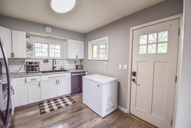 493 Swan Ln, Coldwater, MI 49036 - kitchen with a sink, dishwasher, white refrigerator, backsplash, and white cabinetry