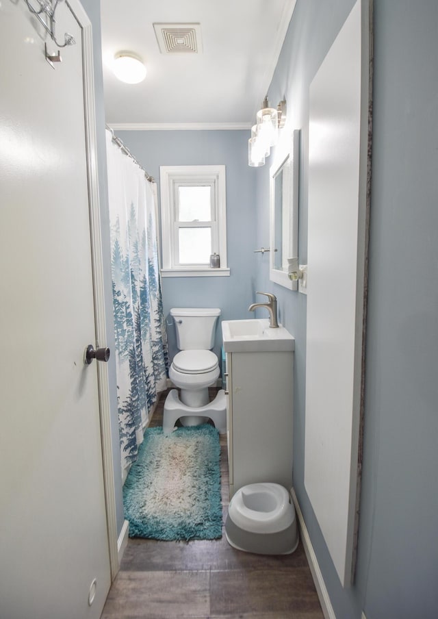 493 Swan Ln, Coldwater, MI 49036 - bathroom featuring toilet, ornamental molding, vanity, wood finished floors, and baseboards