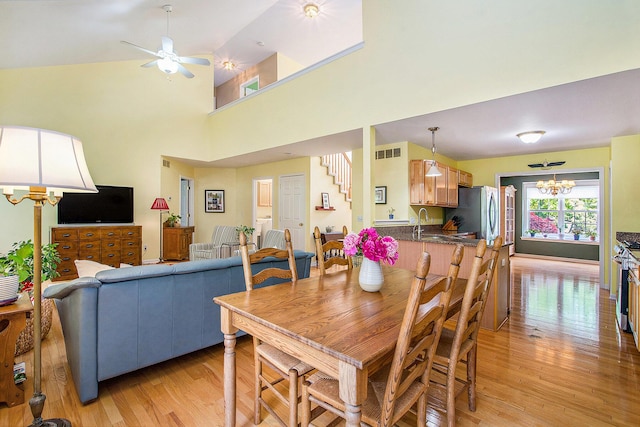 1432 Auston Ln, Chelsea, MI 48118 - dining room featuring a chandelier, light wood-type flooring, and a ceiling fan