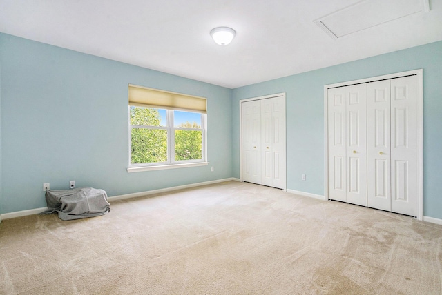 1432 Auston Ln, Chelsea, MI 48118 - unfurnished bedroom with two closets, carpet floors, and baseboards