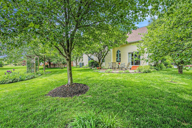 1432 Auston Ln, Chelsea, MI 48118 - view of grassy yard with a patio area