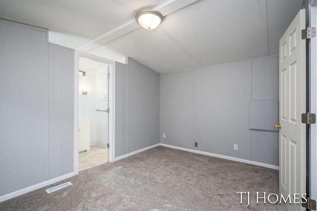 3010 E 96th St, Newaygo, MI 49337 - unfurnished bedroom featuring carpet floors, connected bathroom, vaulted ceiling, and baseboards
