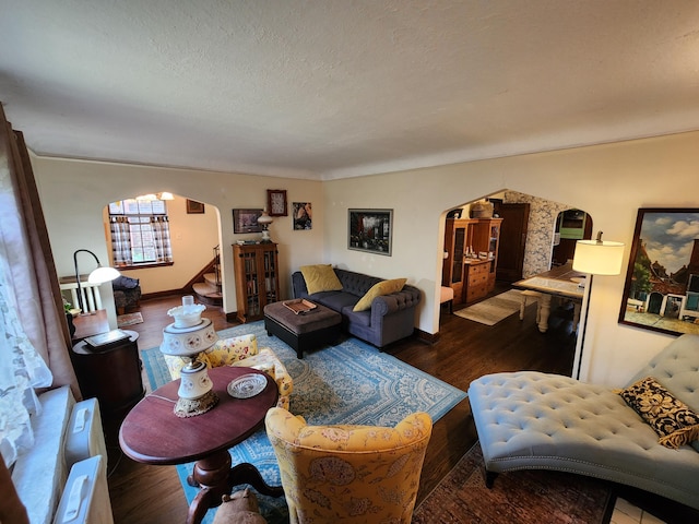 4489 Kensington Ave, Detroit, MI 48224 - living area with arched walkways, wood finished floors, stairs, and a textured ceiling