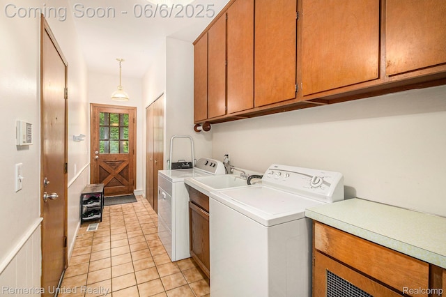 11187 Shadywood Dr, Brighton, MI 48114 - laundry room featuring cabinet space, washing machine and clothes dryer, and light tile patterned floors
