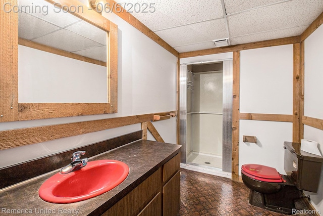 11187 Shadywood Dr, Brighton, MI 48114 - bathroom featuring a drop ceiling, toilet, a stall shower, and vanity
