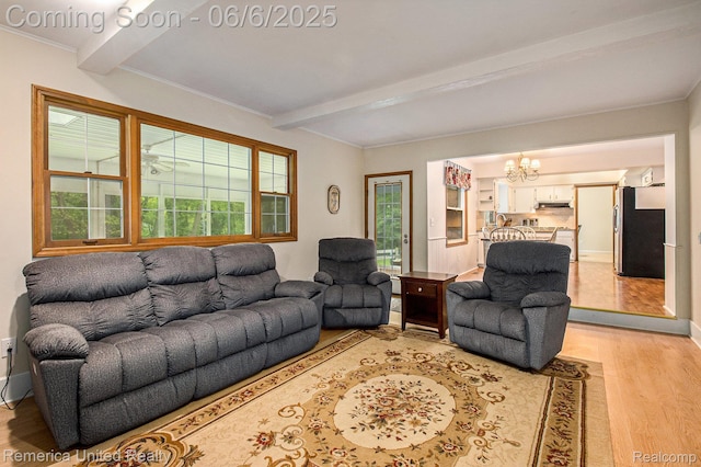 11187 Shadywood Dr, Brighton, MI 48114 - living room featuring beamed ceiling, a chandelier, light wood-type flooring, healthy amount of natural light, and baseboards