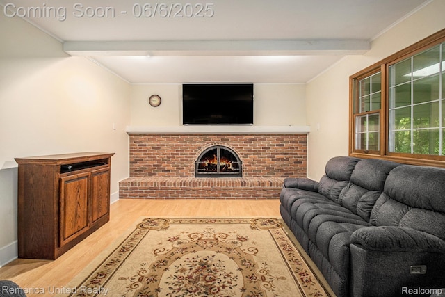 11187 Shadywood Dr, Brighton, MI 48114 - living area with light wood-style flooring, beam ceiling, a brick fireplace, baseboards, and crown molding