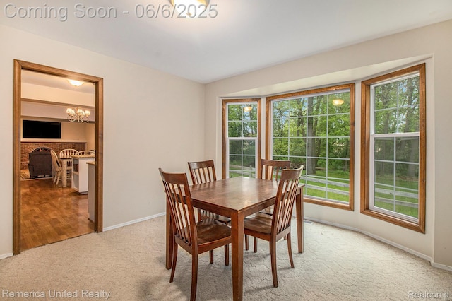 11187 Shadywood Dr, Brighton, MI 48114 - dining space with light carpet, a chandelier, plenty of natural light, and baseboards