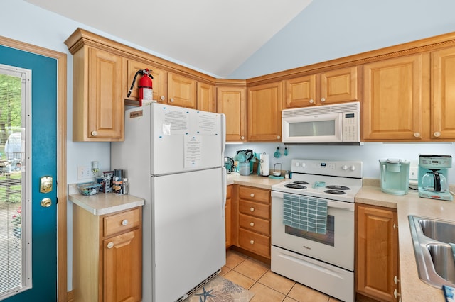8843 Silver Lake Rd, Grand Junction, MI 49056 - kitchen with white appliances, vaulted ceiling, light countertops, a sink, and light tile patterned floors