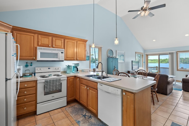 8843 Silver Lake Rd, Grand Junction, MI 49056 - kitchen with white appliances, high vaulted ceiling, a sink, a peninsula, and light tile patterned flooring