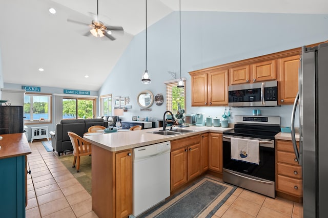 8843 Silver Lake Rd, Grand Junction, MI 49056 - kitchen featuring appliances with stainless steel finishes, a sink, open floor plan, high vaulted ceiling, and light tile patterned floors