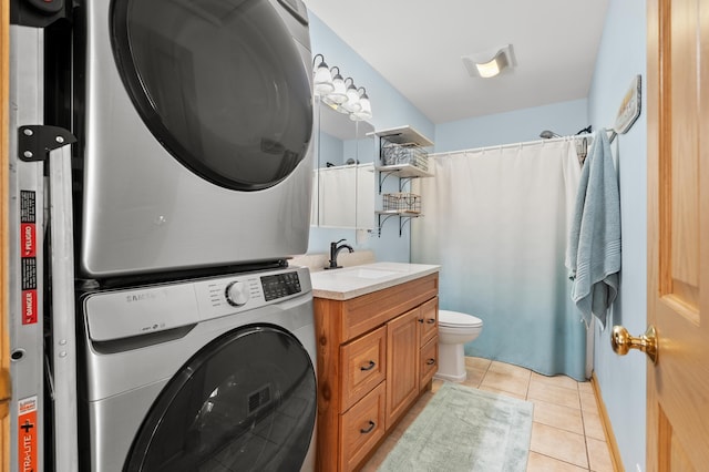 8843 Silver Lake Rd, Grand Junction, MI 49056 - washroom featuring estacked washer and dryer and light tile patterned floors