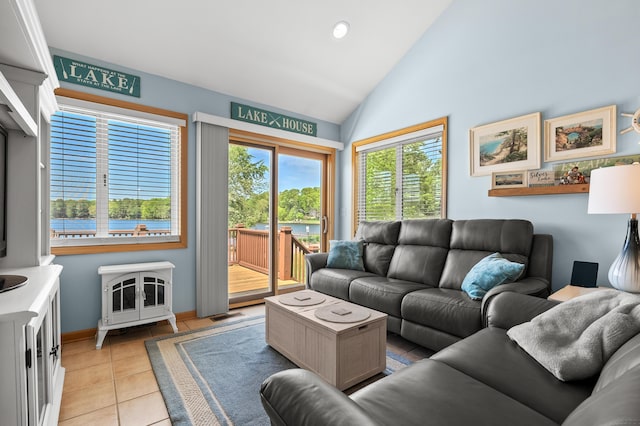 8843 Silver Lake Rd, Grand Junction, MI 49056 - living room featuring light tile patterned flooring, vaulted ceiling, recessed lighting, baseboards, and a water view
