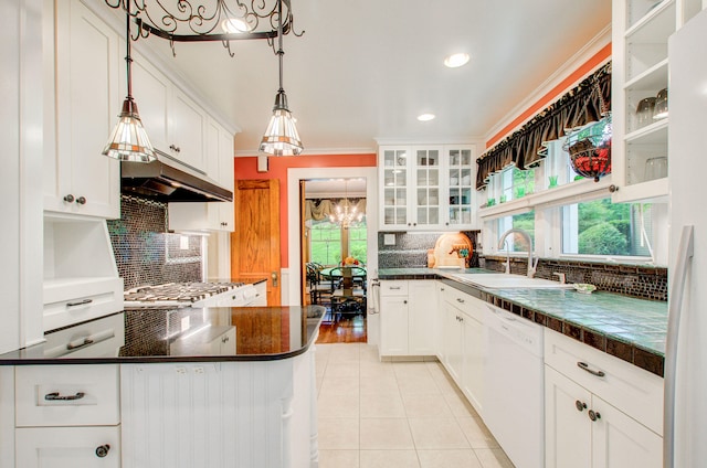 902 Oakridge Dr, Jackson, MI 49203 - kitchen featuring white dishwasher, a sink, light tile patterned floors, dark countertops, and ornamental molding