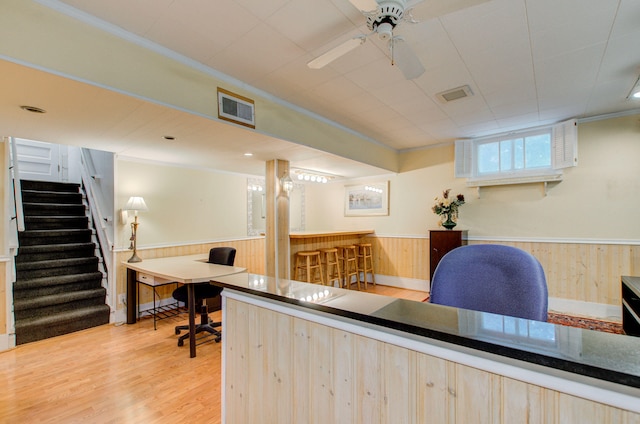 902 Oakridge Dr, Jackson, MI 49203 - office space featuring a dry bar, a wainscoted wall, wood finished floors, wooden walls, and a ceiling fan