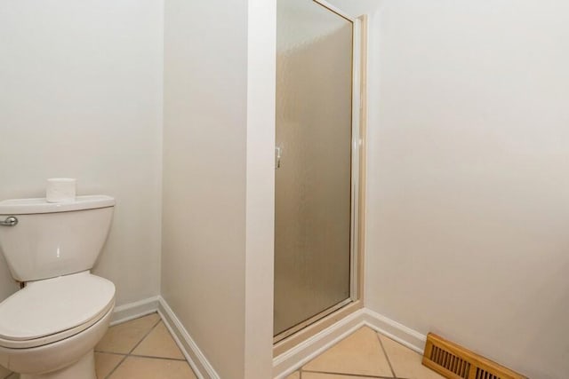 221 S Taylor St, New Buffalo, MI 49117 - full bathroom with tile patterned floors, a stall shower, toilet, and baseboards