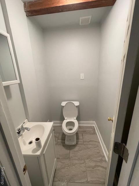 19961 Forrer St, Detroit, MI 48235 - bathroom featuring vanity, toilet, marble finish floors, and baseboards