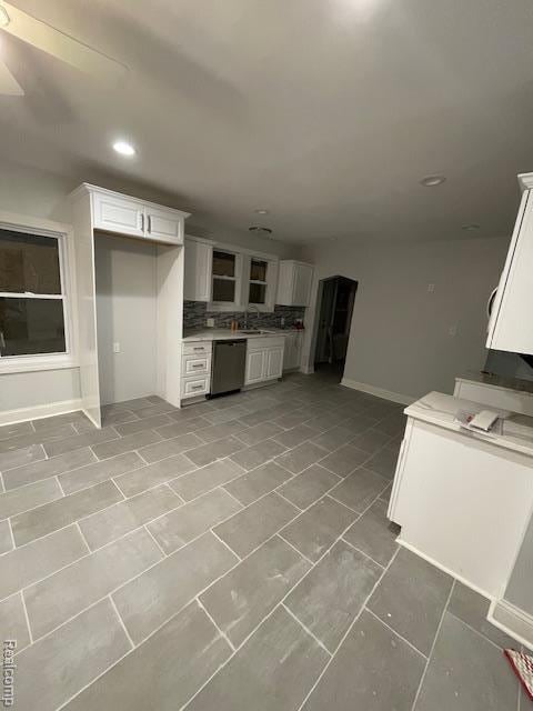 19961 Forrer St, Detroit, MI 48235 - kitchen featuring stainless steel dishwasher, baseboards, white cabinets, tasteful backsplash, and recessed lighting