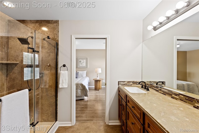 20605 Hickory St, Woodhaven, MI 48183 - full bathroom with connected bathroom, vanity, a shower stall, and baseboards
