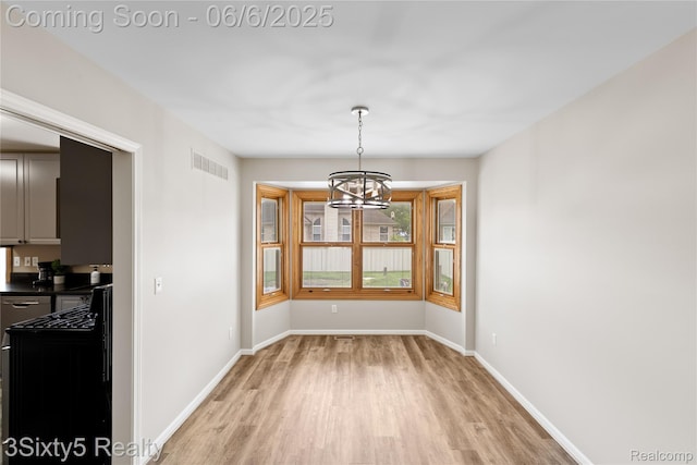 20605 Hickory St, Woodhaven, MI 48183 - unfurnished dining area featuring light wood-type flooring, a chandelier, and baseboards