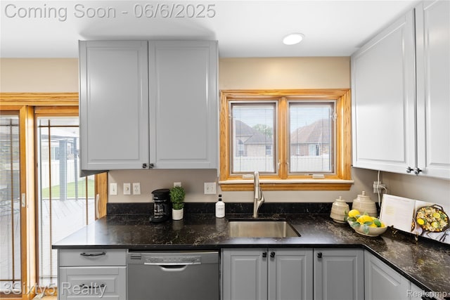 20605 Hickory St, Woodhaven, MI 48183 - kitchen featuring dishwasher, a sink, healthy amount of natural light, and white cabinetry