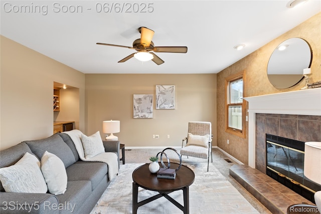 20605 Hickory St, Woodhaven, MI 48183 - carpeted living room featuring ceiling fan, a tiled fireplace, and baseboards