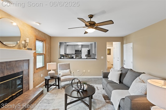 20605 Hickory St, Woodhaven, MI 48183 - living room featuring ceiling fan, carpet flooring, a tile fireplace, and baseboards