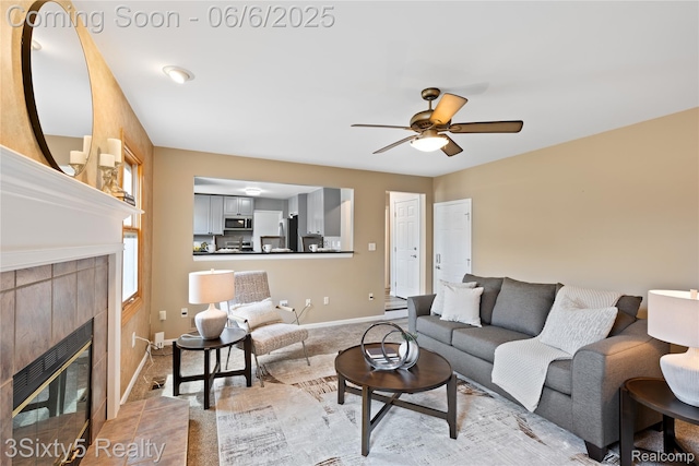 20605 Hickory St, Woodhaven, MI 48183 - living area with a tile fireplace, a ceiling fan, and baseboards
