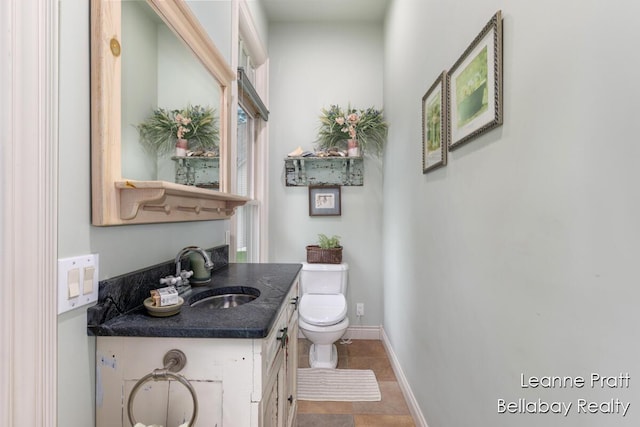 1020 E Woodlawn Ave, Hastings, MI 49058 - bathroom featuring toilet, vanity, and baseboards