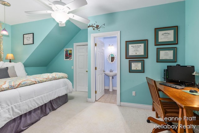 1020 E Woodlawn Ave, Hastings, MI 49058 - carpeted bedroom with baseboards, a sink, ensuite bathroom, ceiling fan, and a desk