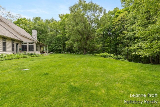 1020 E Woodlawn Ave, Hastings, MI 49058 - view of green lawn with a sunroom