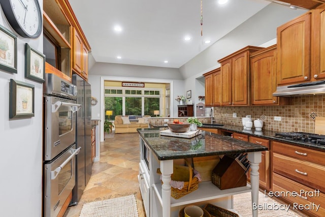1020 E Woodlawn Ave, Hastings, MI 49058 - kitchen with open shelves, under cabinet range hood, black gas cooktop, backsplash, and stainless steel double oven