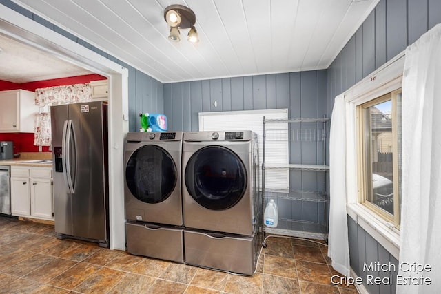 772 26th St SW, Wyoming, MI 49509 - laundry room featuring washer and dryer and dark stone finish floors