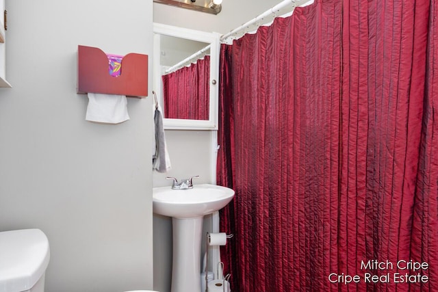 772 26th St SW, Wyoming, MI 49509 - bathroom with toilet and a sink