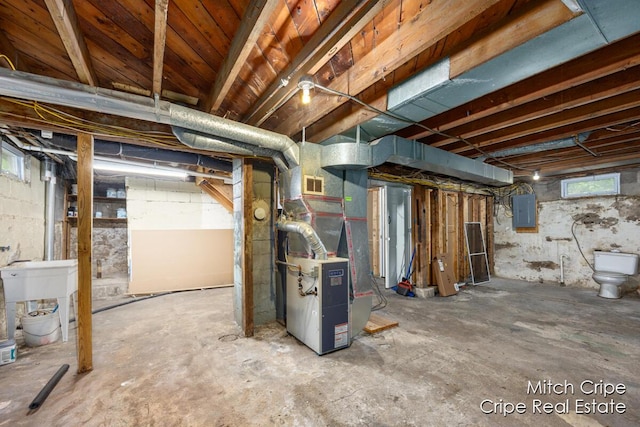 772 26th St SW, Wyoming, MI 49509 - below grade area with electric panel, heating unit, and a sink